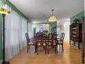 Dining room featuring wood floors, a large mirror, and traditional furniture at 408 Becky St, Orlando, FL 32824