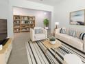 Bright living room boasts stylish furniture, a striped rug, and a decorative bookshelf at 4116 Se 9Th Ave, Ocala, FL 34480