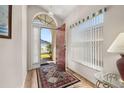 Bright foyer with hardwood floors, an arched entryway, and a view to the outside at 4640 Eagle Peak Dr, Kissimmee, FL 34746