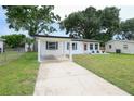 Charming single-story home with a well-manicured lawn, covered carport, and updated exterior at 4824 Shoshone St, Orlando, FL 32819