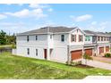 Spacious two-story home with lush green lawn, offering a serene view with its premium location at 4829 Cedar Bay Ter, Kissimmee, FL 34746