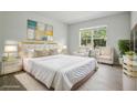 Serene main bedroom with a plush bed, neutral tones, and large windows offering a peaceful retreat at 5079 Royal Point Ave, Kissimmee, FL 34746