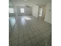Bright living room featuring tile floors, ceiling fan, and sliding mirrored closet doors at 53 W Marbrisa Way, Kissimmee, FL 34743