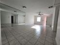 Bright living room with large mirror and neutral tile flooring at 53 W Marbrisa Way, Kissimmee, FL 34743