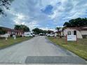 A peaceful street view within the Marbrisa community with sidewalks, landscaping and community signage at 53 W Marbrisa Way, Kissimmee, FL 34743