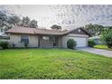 Charming home with a well-maintained front yard, attached garage, and traditional design at 5311 Ansonia Ct, Orlando, FL 32839