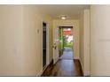 Inviting hallway with wood floors that leads to the front door and other rooms of the home at 5311 Ansonia Ct, Orlando, FL 32839