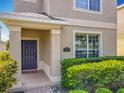Eye-level shot of the house entrance featuring manicured shrubs and the house number at 5772 Laurel Cherry Ave, Winter Garden, FL 34787
