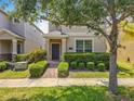 Inviting two-story home featuring manicured hedges and a walkway to the front door at 5772 Laurel Cherry Ave, Winter Garden, FL 34787