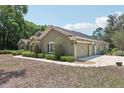 Attached three-car garage provides ample parking and storage space, complemented by tidy landscaping at 6686 Se 135Th St, Summerfield, FL 34491