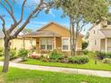 Charming home showcasing a well-manicured front lawn, landscaped garden, and inviting front porch at 6837 Pasturelands Pl, Winter Garden, FL 34787