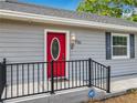 Close up of the newly painted red front door with leaded glass oval window at 731 Guernsey St, Orlando, FL 32804
