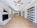 Bright and airy living room with hardwood floors, fireplace, and open to the kitchen at 731 Guernsey St, Orlando, FL 32804
