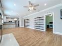 Spacious living room with hardwood floors, white trim, and built in shelving at 731 Guernsey St, Orlando, FL 32804