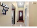 Inviting entryway featuring tile flooring, stylish decor, and a convenient coat closet, creating a welcoming atmosphere at 7616 Southwick St, Orlando, FL 32818