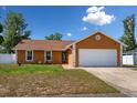 Charming single-story home with a well-manicured lawn and a two-car garage, perfect for suburban living at 7616 Southwick St, Orlando, FL 32818