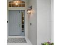 Stylish front door featuring decorative glass, a modern lantern, and a welcoming entrance mat at 811 Wayne Ave, Altamonte Springs, FL 32701