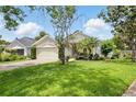 Charming single-Gathering home featuring a manicured lawn, mature trees, and a spacious two-car garage at 811 Wayne Ave, Altamonte Springs, FL 32701