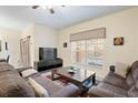 Comfortable living room with neutral tones, plush seating, and natural light from a large window at 8941 Bismarck Palm Rd, Kissimmee, FL 34747