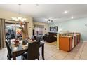 Open-concept living space includes a dining area and modern kitchen with granite countertops at 8941 Bismarck Palm Rd, Kissimmee, FL 34747