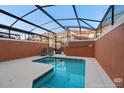 A serene in-ground screened-in pool with lounge chairs and a private backyard at 8941 Bismarck Palm Rd, Kissimmee, FL 34747