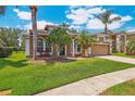 Beautiful home with a two-car garage, freshly manicured lawn, mature landscaping and bench at 10161 Sandy Marsh Ln, Orlando, FL 32832