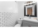 Modern bathroom showcasing subway tile backsplash and a sleek gray vanity with ample storage at 1094 Henry Balch Dr, Orlando, FL 32810