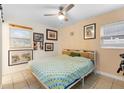 Cozy bedroom featuring a ceiling fan, natural light, and stylishly framed wall decor at 1094 Henry Balch Dr, Orlando, FL 32810