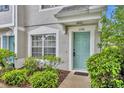 Welcoming front entrance with vibrant, light teal-colored door and well-maintained landscaping at 1150 Vineland Pl, Lake Mary, FL 32746