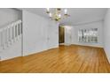 Spacious living room with hardwood floors, chandelier, and bright natural light at 1150 Vineland Pl, Lake Mary, FL 32746