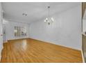 Bright living room featuring hardwood floors and a stylish chandelier at 1150 Vineland Pl, Lake Mary, FL 32746