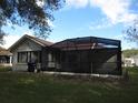 Exterior of the home's screened-in patio, providing an outdoor living area at 11540 Sandy Hill Dr, Orlando, FL 32821