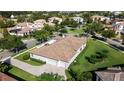A beautiful suburban home and neighborhood showcasing a well-maintained yard and three-car garage at 11706 Waterstone Loop Dr, Windermere, FL 34786