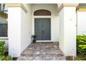 Close up of the beautiful, stately double front doors framed by grand white columns at 11706 Waterstone Loop Dr, Windermere, FL 34786