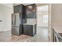 Modern kitchen featuring stainless steel appliances and dark cabinets at 11807 Charades St, Orlando, FL 32832