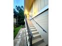 Staircase leads to the entrance of a tan and well-lit home at 130 Jasmine Woods Ct # 3D, Deltona, FL 32725