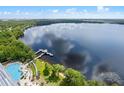 Breathtaking aerial view features a resort-style pool, lakeside dock and lush green landscaping for peaceful community living at 13427 Blue Heron Beach Dr # 1907, Orlando, FL 32821
