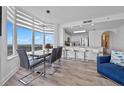 Bright, airy dining area with modern table and expansive windows showcasing scenic views, seamlessly connected to the kitchen at 13427 Blue Heron Beach Dr # 1907, Orlando, FL 32821