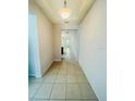 Bright hallway with tile flooring leads to the kitchen area providing clear sightlines throughout the home at 1726 Brassie Ct, Kissimmee, FL 34746