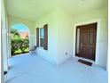 Welcoming front porch with a view and a stylish brown front door at 1726 Brassie Ct, Kissimmee, FL 34746