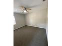 This bedroom features neutral walls, carpeted floors, and a ceiling fan at 1880 N Crystal Lake Dr # 3, Lakeland, FL 33801