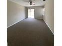 This bedroom features neutral walls, carpeted floors, and sliding glass door access at 1880 N Crystal Lake Dr # 3, Lakeland, FL 33801