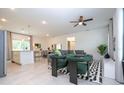 Bright, open-concept living room featuring modern decor, tiled floors, and a ceiling fan at 2024 Sw 153Rd Loop, Ocala, FL 34473