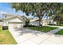 Beautiful single-Gathering home showcases manicured lawns, mature landscaping, and a spacious driveway at 2648 Daulby St, Kissimmee, FL 34747