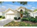 Inviting two-story home features a lush green lawn and mature landscaping, offering great curb appeal at 2648 Daulby St, Kissimmee, FL 34747