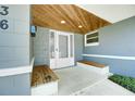 Close up view of the home entrance showcasing wooden ceiling accents and built-in benches at 2736 Shannon Rd, Orlando, FL 32806