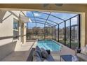 Screened in outdoor pool with a lounge area, providing a private and relaxing retreat at 2821 Bookmark Dr, Kissimmee, FL 34746