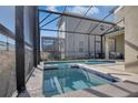 View of the pool and integrated spa and screened-in lanai, perfect for relaxation and privacy at 2821 Bookmark Dr, Kissimmee, FL 34746