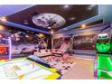 Amusement-style game room, featuring air hockey, skee ball, and wall-to-wall custom graphic design at 2836 Simile St, Kissimmee, FL 34746