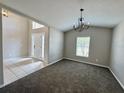 Bright and spacious living room with neutral paint, carpet, and plenty of natural light at 3049 Buckeye Pointe Dr, Winter Haven, FL 33881